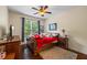 Comfortable bedroom with neutral walls, wood flooring and a bright window at 414 Silver Top Dr, Grayson, GA 30017
