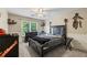 Stylish bedroom with a dark wood bed frame, neutral walls, and a large window providing natural light at 414 Silver Top Dr, Grayson, GA 30017
