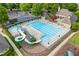 Large community pool with a water slide, lounge chairs, and umbrellas at 414 Silver Top Dr, Grayson, GA 30017