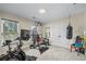 Bright exercise room with ample equipment including a stationary bike and weight training machine at 414 Silver Top Dr, Grayson, GA 30017