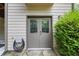 Exterior door with glass panels surrounded by mature landscaping and stone pathway at 414 Silver Top Dr, Grayson, GA 30017