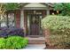 Charming brick home featuring an elegant front door and lush landscaping at 414 Silver Top Dr, Grayson, GA 30017