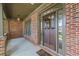 Inviting covered porch with brick columns, sidelights and craftsman-style front door at 414 Silver Top Dr, Grayson, GA 30017