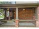 Inviting front porch with brick pillars, neutral railings, and pendant lights at 414 Silver Top Dr, Grayson, GA 30017