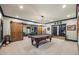 This Game Room is ready for fun with a pool table, bar area, and barn doors for added entertainment at 414 Silver Top Dr, Grayson, GA 30017