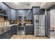 Bright kitchen with stainless steel appliances, custom cabinets, wine rack, and stone countertops at 414 Silver Top Dr, Grayson, GA 30017
