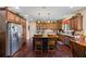 Spacious kitchen featuring a center island, custom wood cabinets, and stainless steel appliances at 414 Silver Top Dr, Grayson, GA 30017