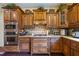 Close-up of kitchen with stainless steel oven and gas stovetop amid custom wood cabinets at 414 Silver Top Dr, Grayson, GA 30017