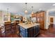 Spacious kitchen with dark wood cabinets, a center island, and an adjacent breakfast area at 414 Silver Top Dr, Grayson, GA 30017