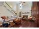 Cozy living room with fireplace, dark hardwood floors and staircase at 414 Silver Top Dr, Grayson, GA 30017