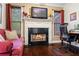 Cozy living room with a fireplace, dark wood floors, and lots of natural light at 414 Silver Top Dr, Grayson, GA 30017