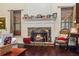 Cozy living room featuring a stone fireplace with decorative mantel and hardwood floors at 414 Silver Top Dr, Grayson, GA 30017