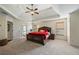 Spacious main bedroom features a tray ceiling, a ceiling fan, and windows that let in ample natural light at 414 Silver Top Dr, Grayson, GA 30017