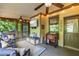 Inviting screened porch with comfortable seating, ceiling fan, and beverage cooler, perfect for outdoor relaxation at 414 Silver Top Dr, Grayson, GA 30017