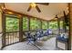 Relaxing screened porch with outdoor seating and ceiling fans overlooking a wooded backyard at 414 Silver Top Dr, Grayson, GA 30017