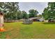 Large backyard featuring a pool, trampoline, covered area and boat at 1050 Kirkland Rd, Covington, GA 30016