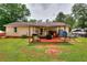 Backyard features a covered patio, outdoor furniture, a grill, and ample space at 1050 Kirkland Rd, Covington, GA 30016
