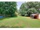 Spacious backyard offering ample green space, with chain link fencing and storage at 1050 Kirkland Rd, Covington, GA 30016