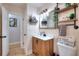 Bathroom features a wood vanity with shelves, mirror, and a white toilet at 1050 Kirkland Rd, Covington, GA 30016