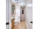 Small bathroom with hardwood floors, wood cabinet with white sink and black faucet at 1050 Kirkland Rd, Covington, GA 30016