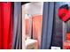 This compact bathroom showcases updated vanity and a stall shower with orange shower curtain at 1050 Kirkland Rd, Covington, GA 30016