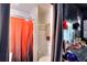 The bathroom features a stall shower with a orange shower curtain, new vanity, and mounted storage at 1050 Kirkland Rd, Covington, GA 30016