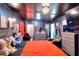 This bedroom features dark walls, an orange comforter, and rustic wooden dressers at 1050 Kirkland Rd, Covington, GA 30016