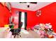 Bright bedroom with red walls, window, ceiling fan, and various toys at 1050 Kirkland Rd, Covington, GA 30016