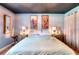 Relaxing bedroom with light blue walls, a dark ceiling, wood decor and a large bed at 1050 Kirkland Rd, Covington, GA 30016