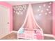 Cozy pink and grey bedroom designed for a , complete with a stylish canopy and soft carpet at 1050 Kirkland Rd, Covington, GA 30016