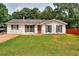 Charming single-story home with well-maintained lawn and inviting curb appeal and beautiful landscaping at 1050 Kirkland Rd, Covington, GA 30016