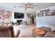 Open-concept living room with stone fireplace, hardwood floors, and plenty of natural light at 1050 Kirkland Rd, Covington, GA 30016