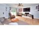 Bright living room features hardwood floors, a ceiling fan, and a cozy fireplace at 1050 Kirkland Rd, Covington, GA 30016