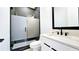 Modern bathroom with glass-enclosed shower, vanity, and black hardware at 1102 Morley Se Ave, Atlanta, GA 30312
