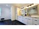 Bright bathroom featuring double vanity, sleek black fixtures, and striking black marble-patterned flooring at 1102 Morley Se Ave, Atlanta, GA 30312