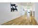 Hallway featuring hardwood floors, white walls, and modern artwork at 1102 Morley Se Ave, Atlanta, GA 30312