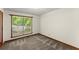 A room featuring a large window with views of greenery and neutral walls at 4949 Woodland Nw Way, Acworth, GA 30102