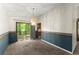 Dining room with carpet, slider door to deck, chair rail, and view into the kitchen at 4949 Woodland Nw Way, Acworth, GA 30102
