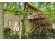 Back exterior features a wooded lot, deck with privacy lattice, and a back door at 4949 Woodland Nw Way, Acworth, GA 30102