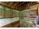 Inviting covered hot tub with privacy lattice and wooden deck surrounded by trees at 4949 Woodland Nw Way, Acworth, GA 30102