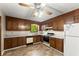 Traditional kitchen with wood cabinets, neutral countertops, and vinyl flooring at 4949 Woodland Nw Way, Acworth, GA 30102