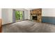 Living room features stone fireplace, carpeted floor, large window, and wainscotting at 4949 Woodland Nw Way, Acworth, GA 30102