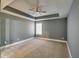 Spacious bedroom with tray ceiling, ceiling fan, and neutral carpeting at 6269 Colonial Vw, Fairburn, GA 30213