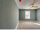 Bright bedroom featuring fresh paint and neutral carpeting with a ceiling fan at 6269 Colonial Vw, Fairburn, GA 30213