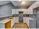 Modern kitchen with white cabinets, quartz countertops, and stainless steel sink at 6269 Colonial Vw, Fairburn, GA 30213