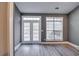 Bright living space featuring fresh paint, a large window, and access to an outdoor patio at 6269 Colonial Vw, Fairburn, GA 30213