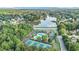 Aerial view featuring a community pool, tennis courts, clubhouse, and a scenic lake at 265 Lee River Cv, Suwanee, GA 30024