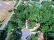 Stunning aerial view of a house nestled amongst lush greenery, showcasing its prime location and curb appeal at 265 Lee River Cv, Suwanee, GA 30024