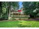 Beautiful home showcasing a spacious backyard, a large deck for outdoor gatherings, and lush greenery at 265 Lee River Cv, Suwanee, GA 30024