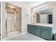 Bathroom with a shower and vanity features a classic black and white tiled floor at 265 Lee River Cv, Suwanee, GA 30024